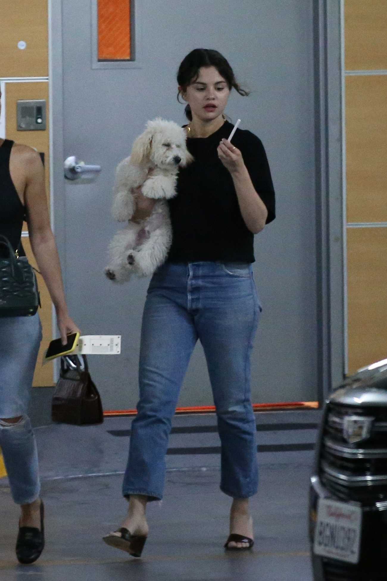 Selena_Gomez_-_leaving_a__Shark_Tank__filming_studio_with_her_puppy_in_West_Hollywood_September_232C_2019-02.jpg